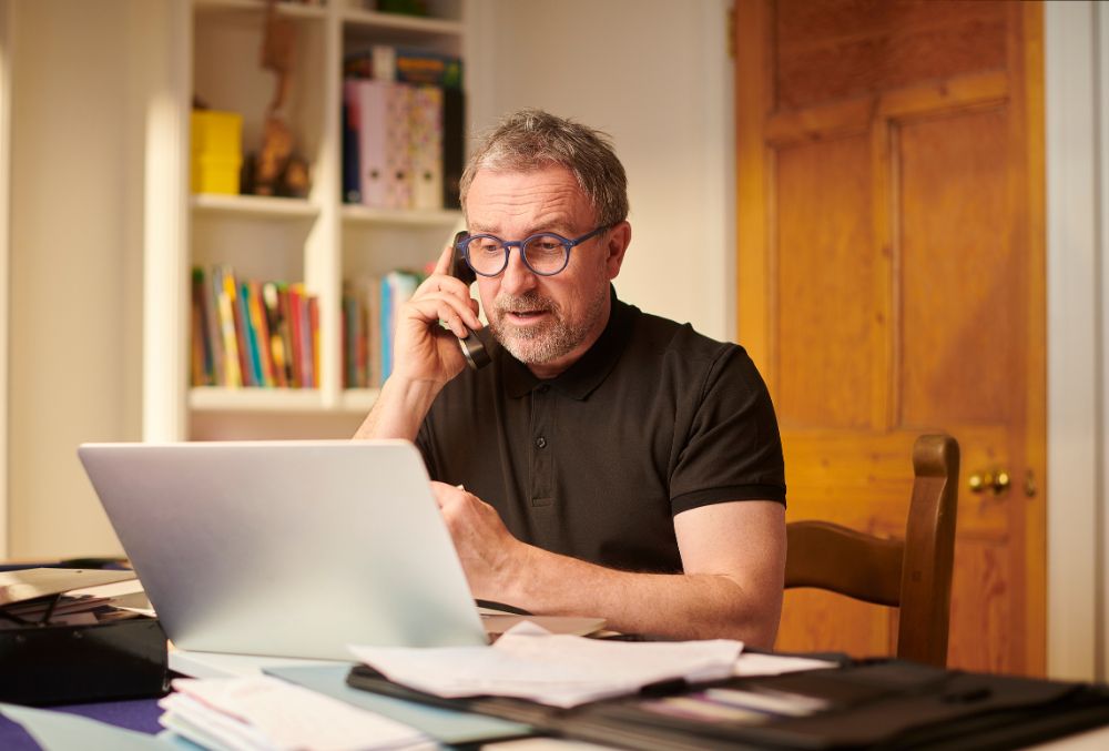 Business Owner On Phone After Identifying The Early Warning Signs His Business Is Becoming Insolvent