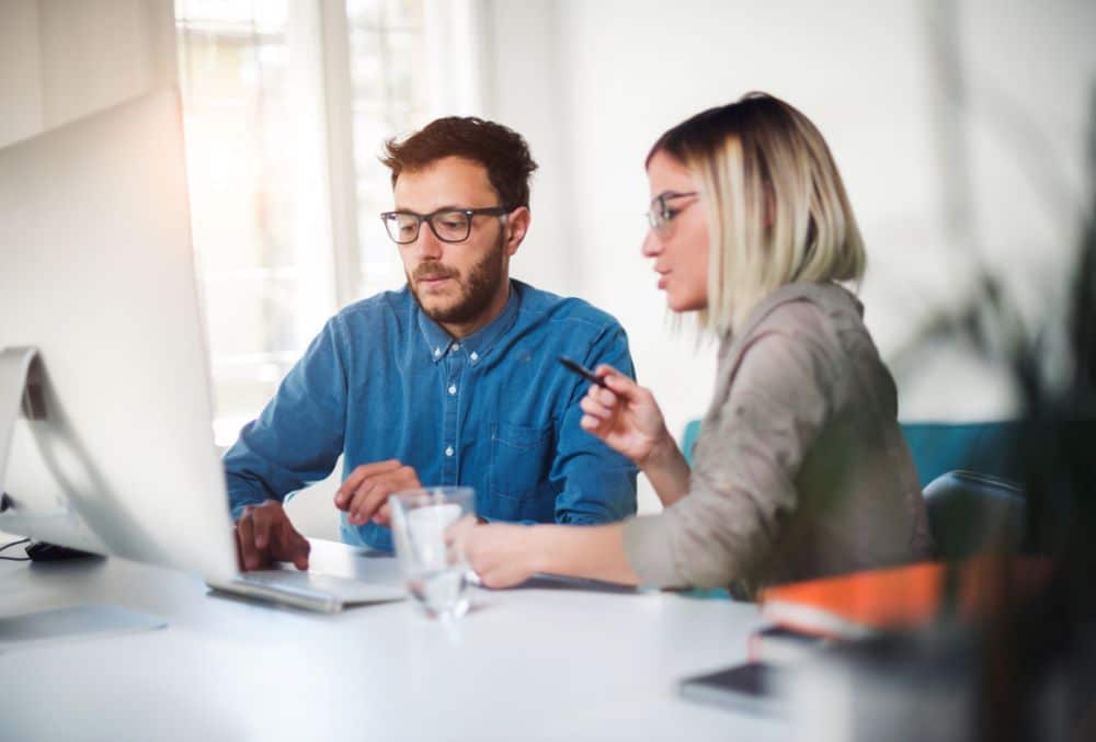 Business owners in front of a computer Trading While Insolvent