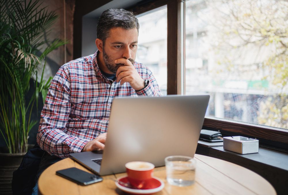 Business Owner Reviewing ATO Payment Plans While Having A Coffee